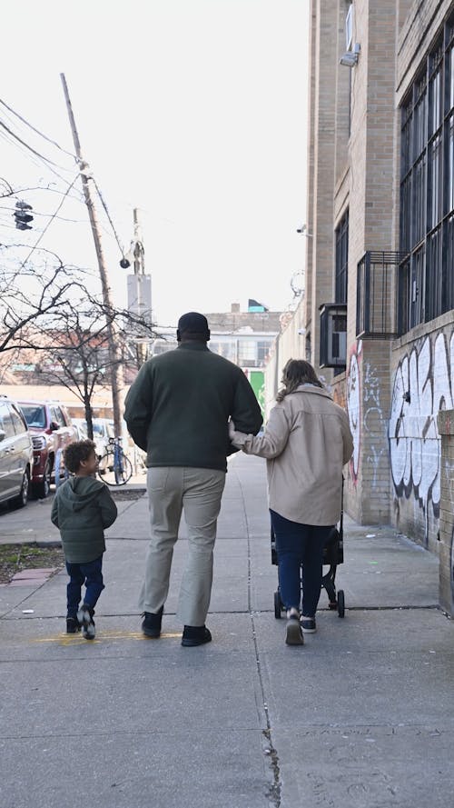 Father and Mother with Kids Strolling