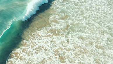 waves hitting beach shore