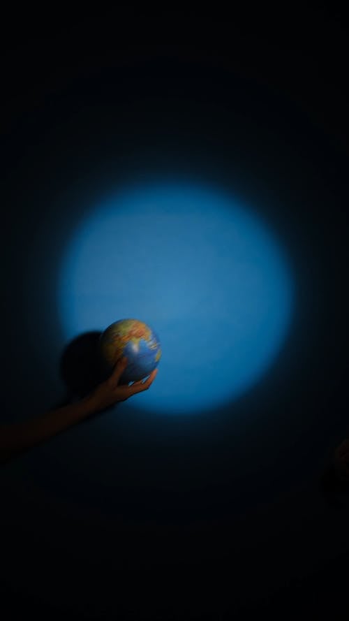 Person holding Globe