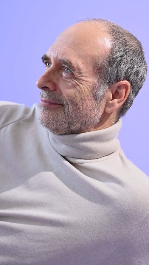 Elderly Man Lying on Purple Floor