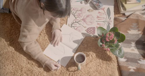 A Woman Drawing in Her Notebook 