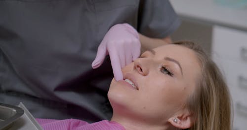 Dentist Examining Teeth of Patient