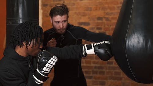 A Boxer Hitting a Punching Bag in Training