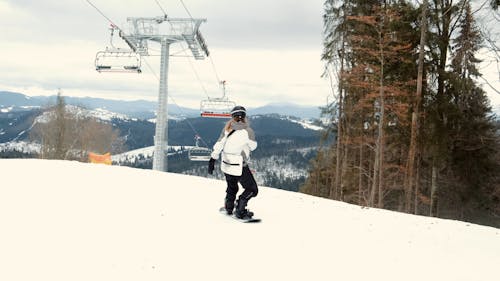 A Female Snowboarder Falling