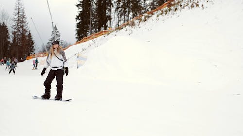 A Video of a Woman Snowboarding