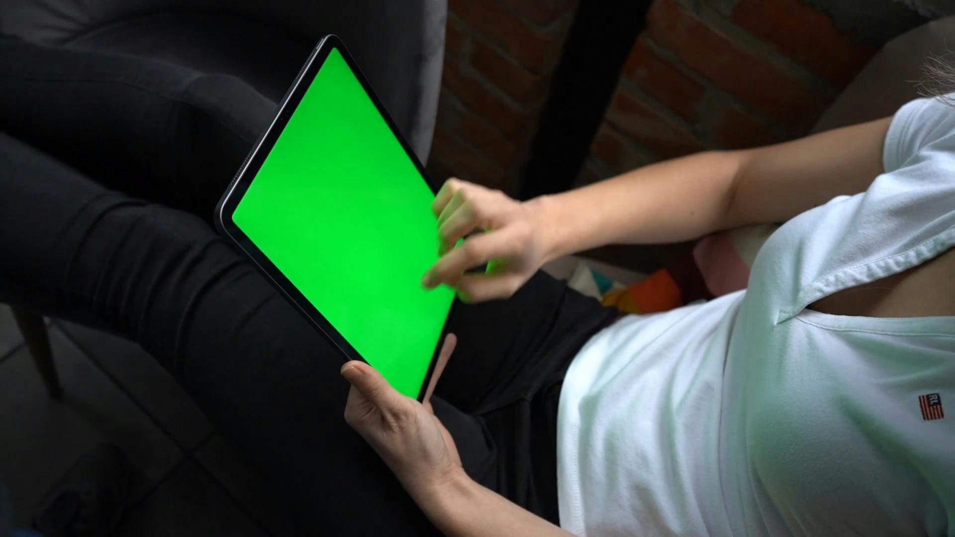 A Woman is Using an iPad with Green Screen · Free Stock Video