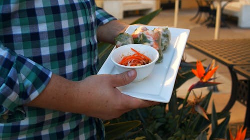 Man Carrying a Plate of Vietnamese Fresh Spring Rolls