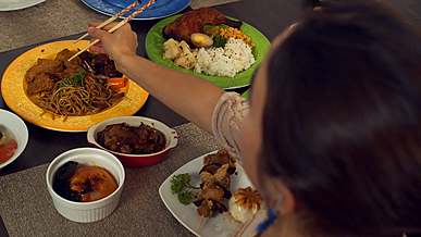 woman putting food on her plate
