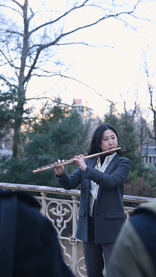 Woman Playing the Flute in Public 
