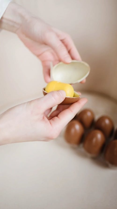 A Person Opening a Chocolate Egg