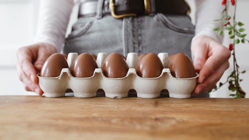 Woman Holding Tray With Chocolate Eggs