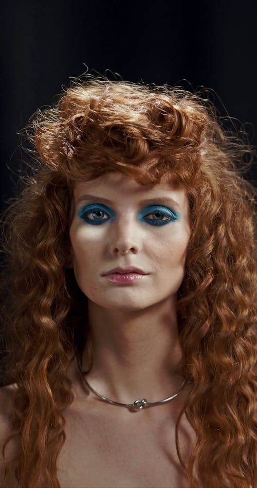 A Female Model with Blue Eye Makeup Posing for the Camera