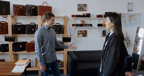 A Man Sitting Down with a Female Client