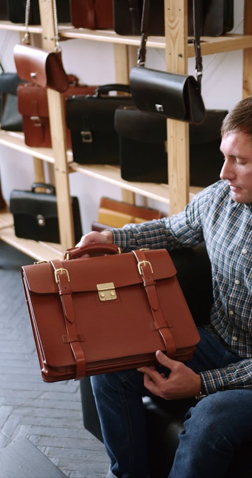 A Woman and a Man Looking at a Brown Leather Briefcase
