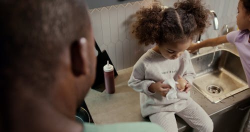 Kids Helping their Father to Cook