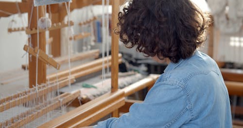 Woman Working with Weaving Loom