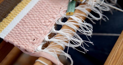 Tape Measure and Threads on a Loom