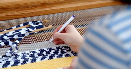 Person Marking Fabric With a Pen