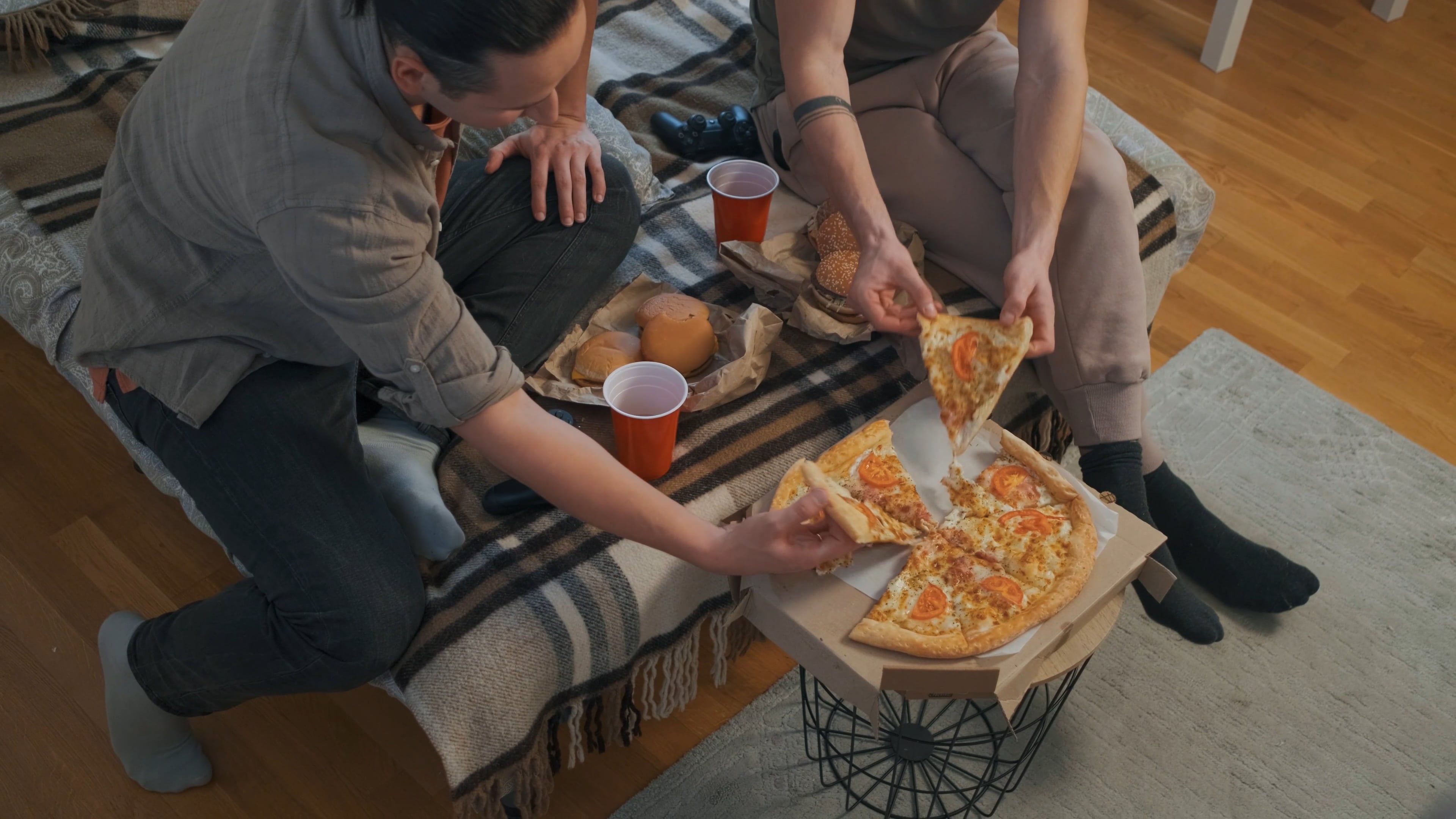Young Men Eating Pizza and Hamburgers on Bed Free Stock Video Footage ...