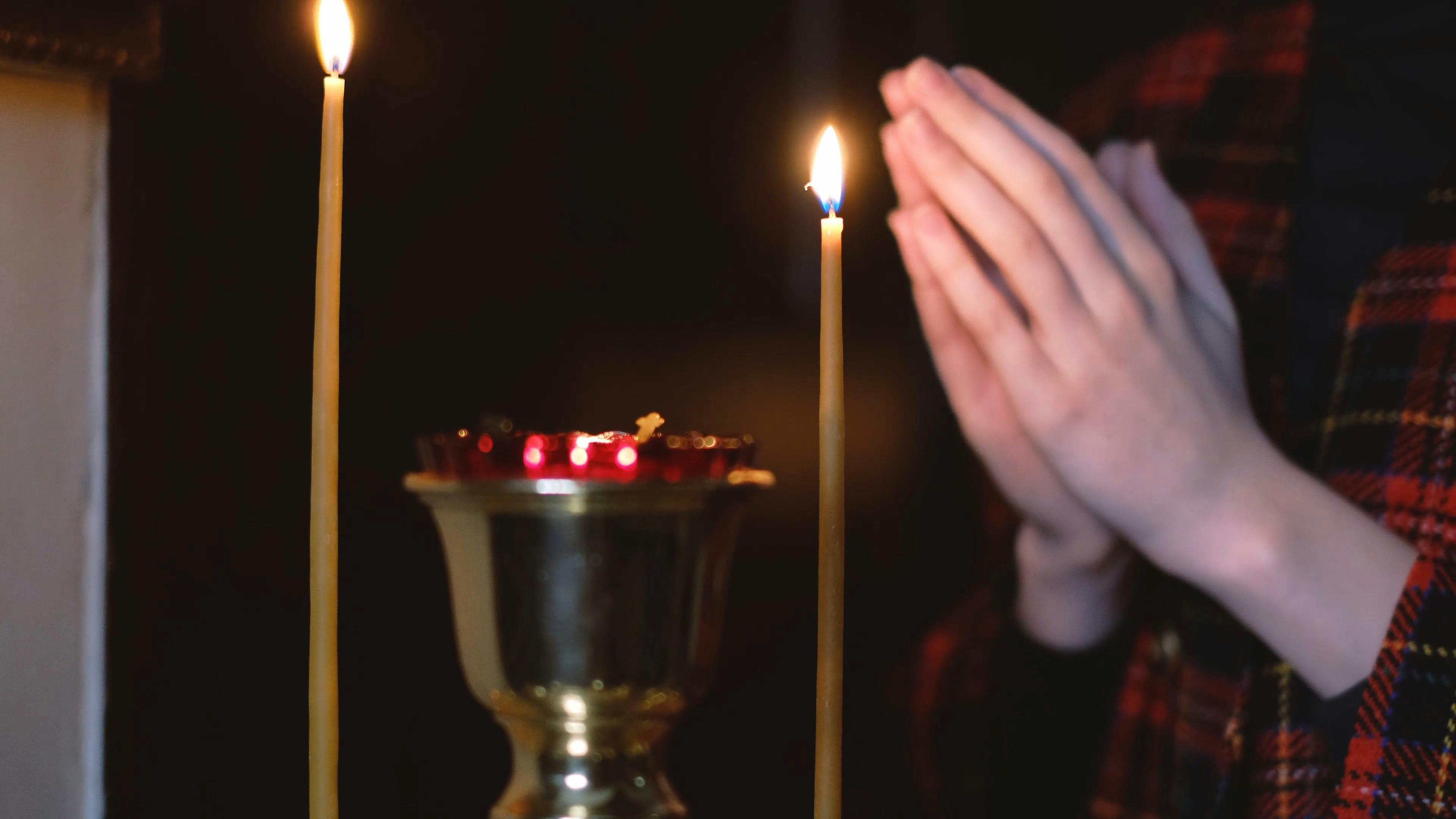 Person Praying With Candles · Free Stock Video
