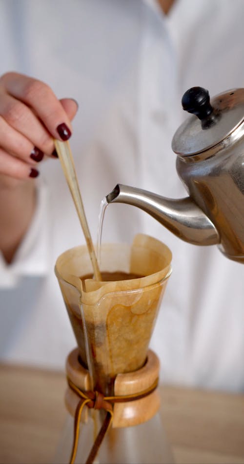 Woman Pouring a Hot Water to the Coffee Filter
