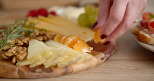 Arranging Oranges on a Wooden Tray