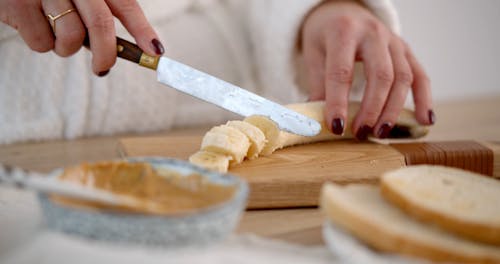 Woman Slicing a Banana