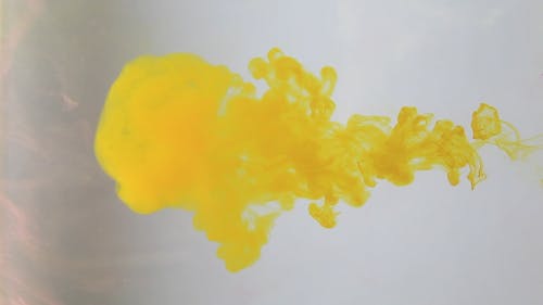 Slow Motion Video of a Yellow Paint in Water