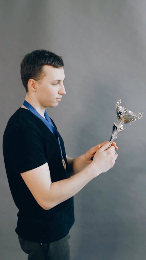 Man Celebrating with a Trophy 