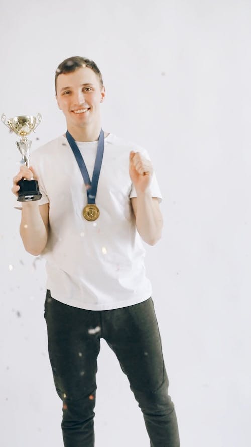 A  Medalist Teenager Holding a Trophy