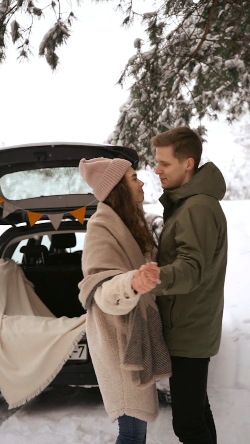 A Couple Doing a Sweet Dance while Snowing