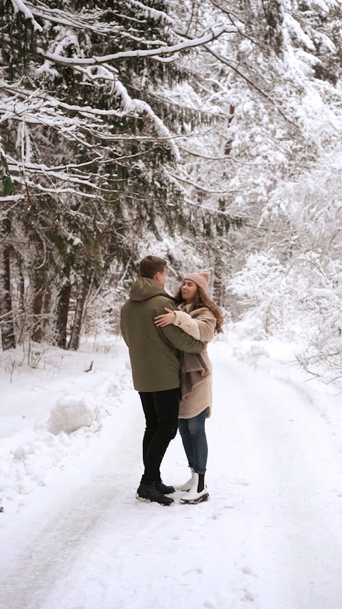 A Couple  Dancing on the Snow in a Winter Forest