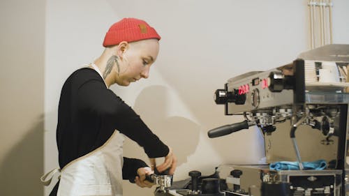 A Woman using a Coffee Maker 