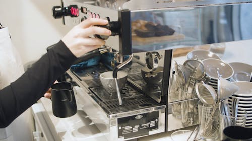 A Person using a Coffee Maker