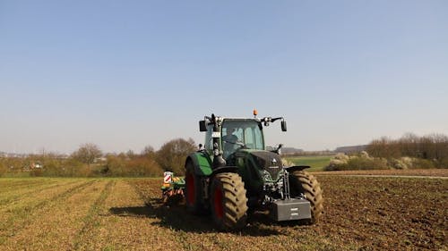 A Tractor Plowing the Field