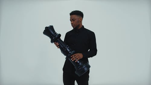 A Man Holding a Big Chess Piece