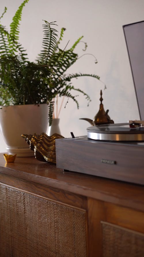 Table with Record Player and Laughing Buddha Figurine