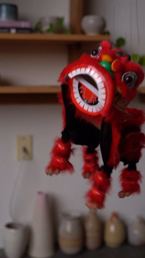 A Dancing Lion Puppet In Strings