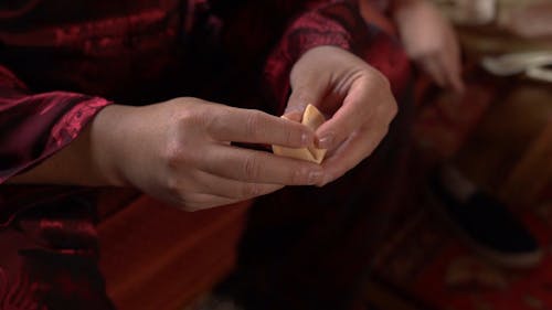 A Man Breaking A Fortune Cookie