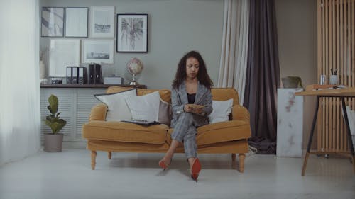 Woman Counting Money on the Couch