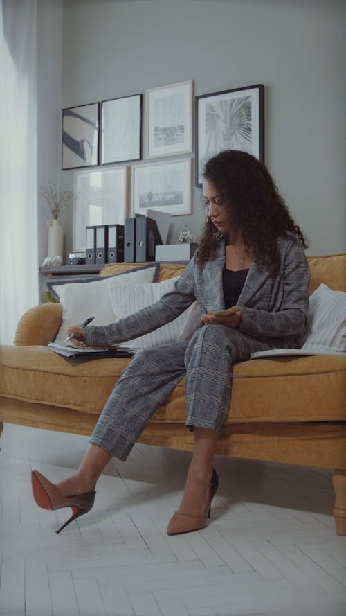 Woman Counting Money on the Couch