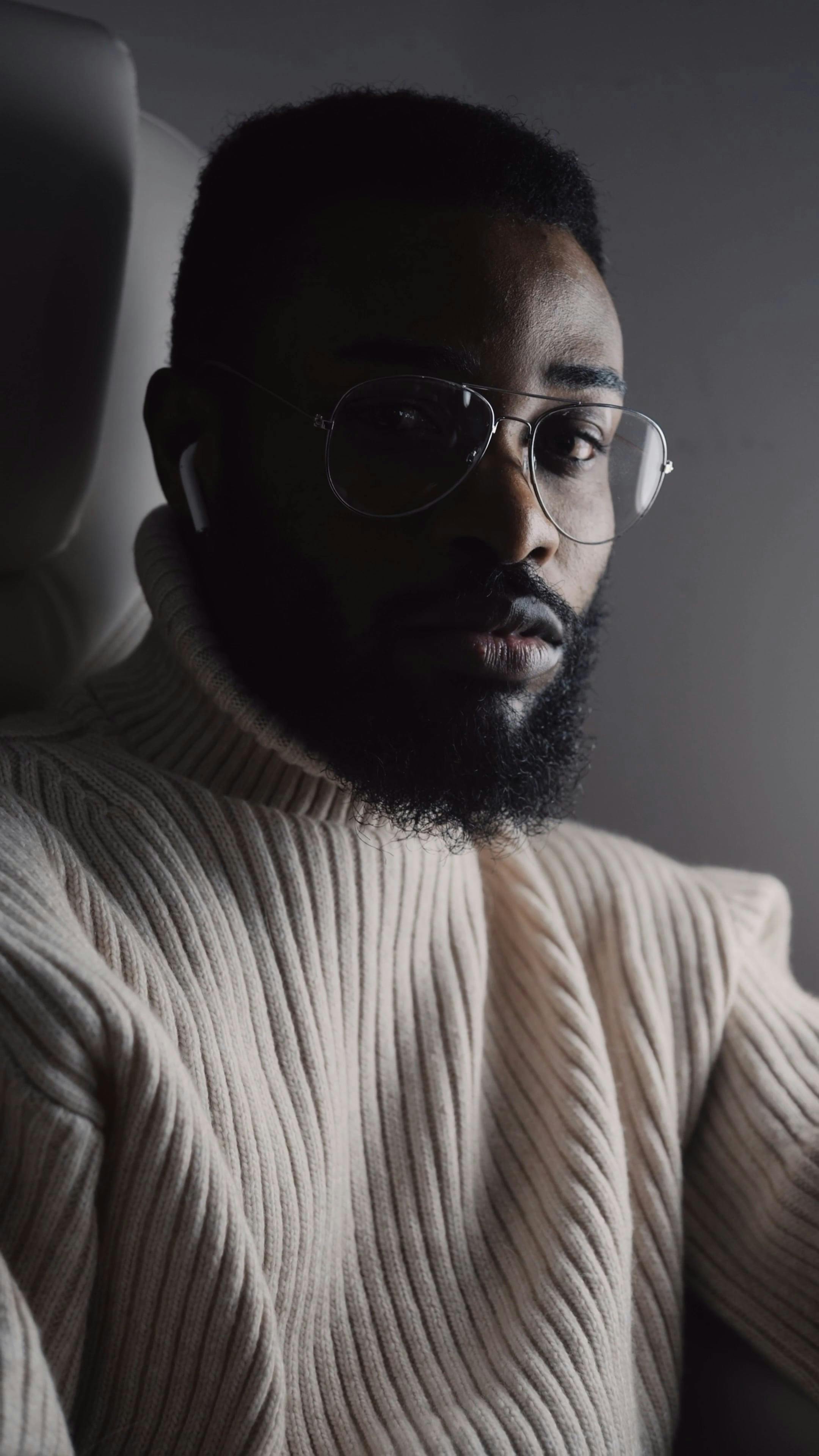 A Man Wearing Ear Pods Looking in the Camera
