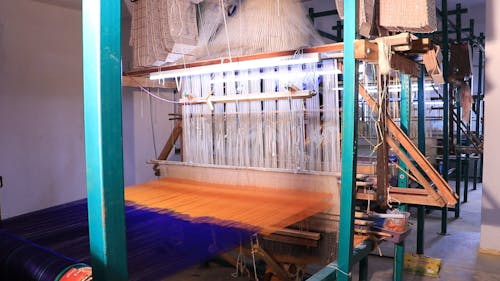 Woman Working with Weaving Loom