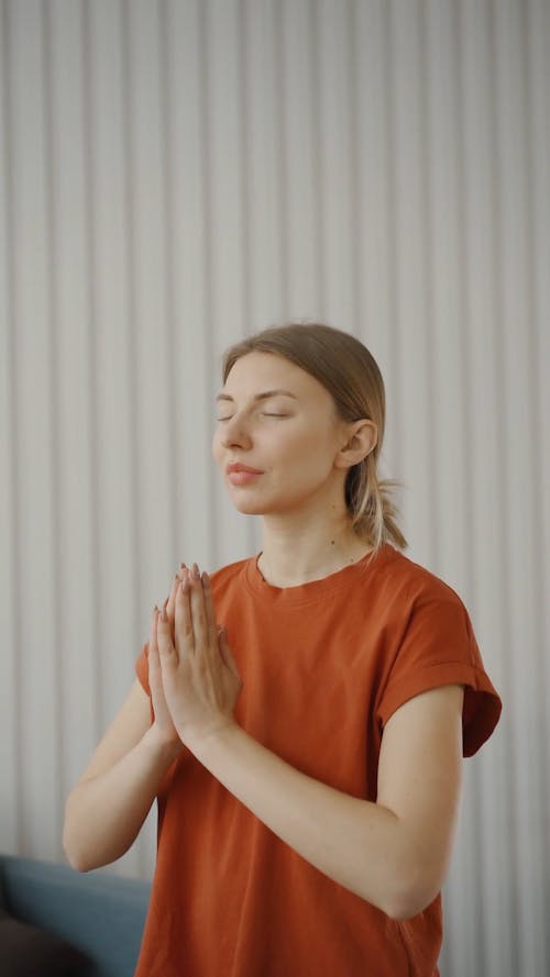A Woman Meditating At Home