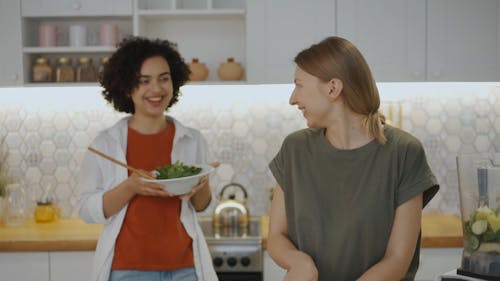 Two Woman Preparing Healthy Foods In The Kitchen
