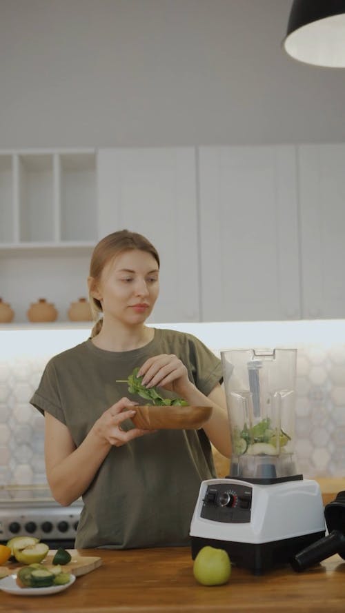 A Woman Preparing A Healthy Drink Of Fresh Fruits And Vegetables