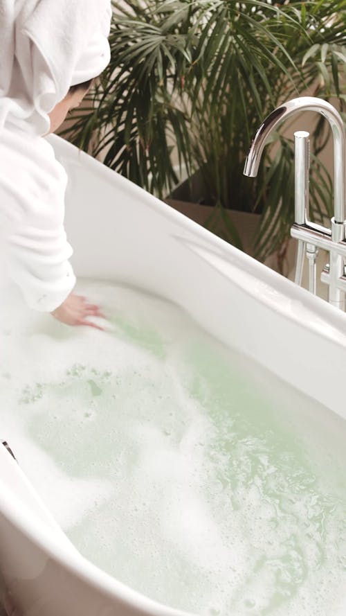 Woman Preparing her Bathtub