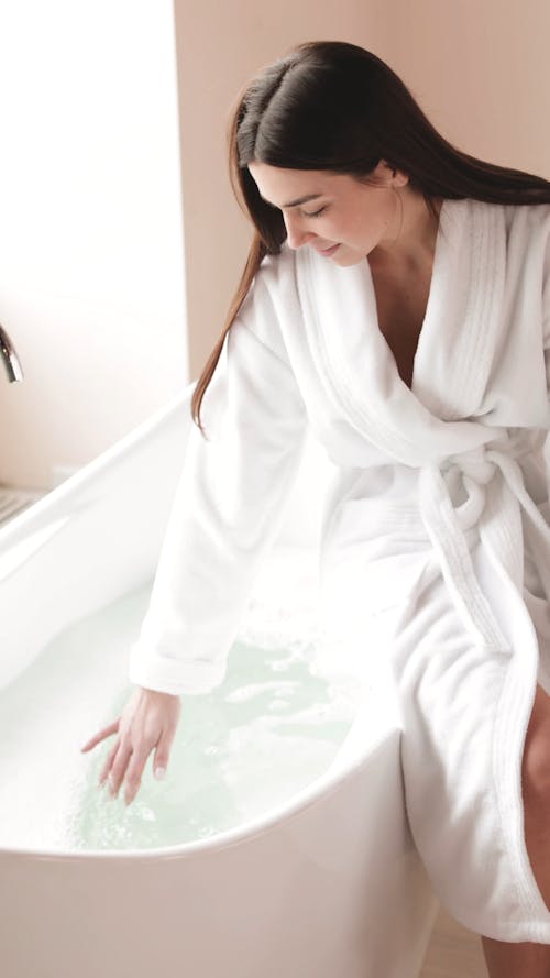 Woman Preparing her Bath in the Bathtub