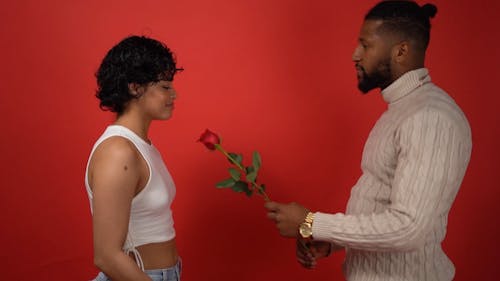 Man Giving a Red Rose to His Woman