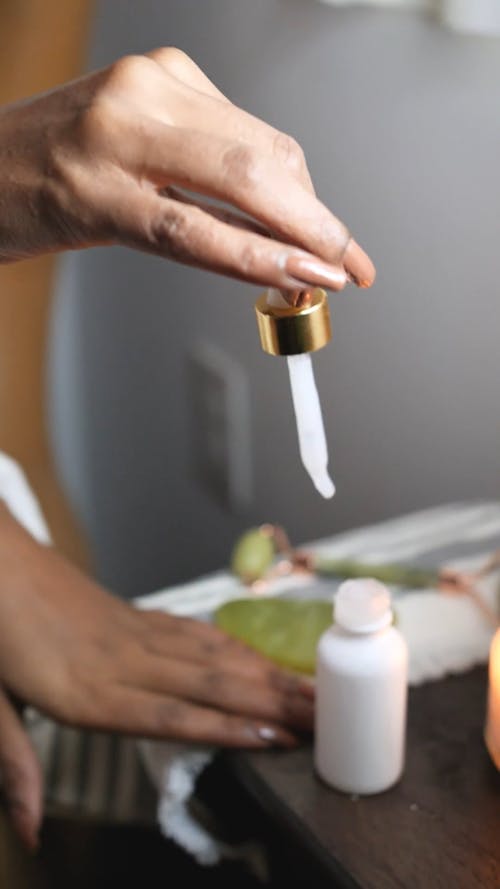 A Woman Putting Lotion on Her Hands